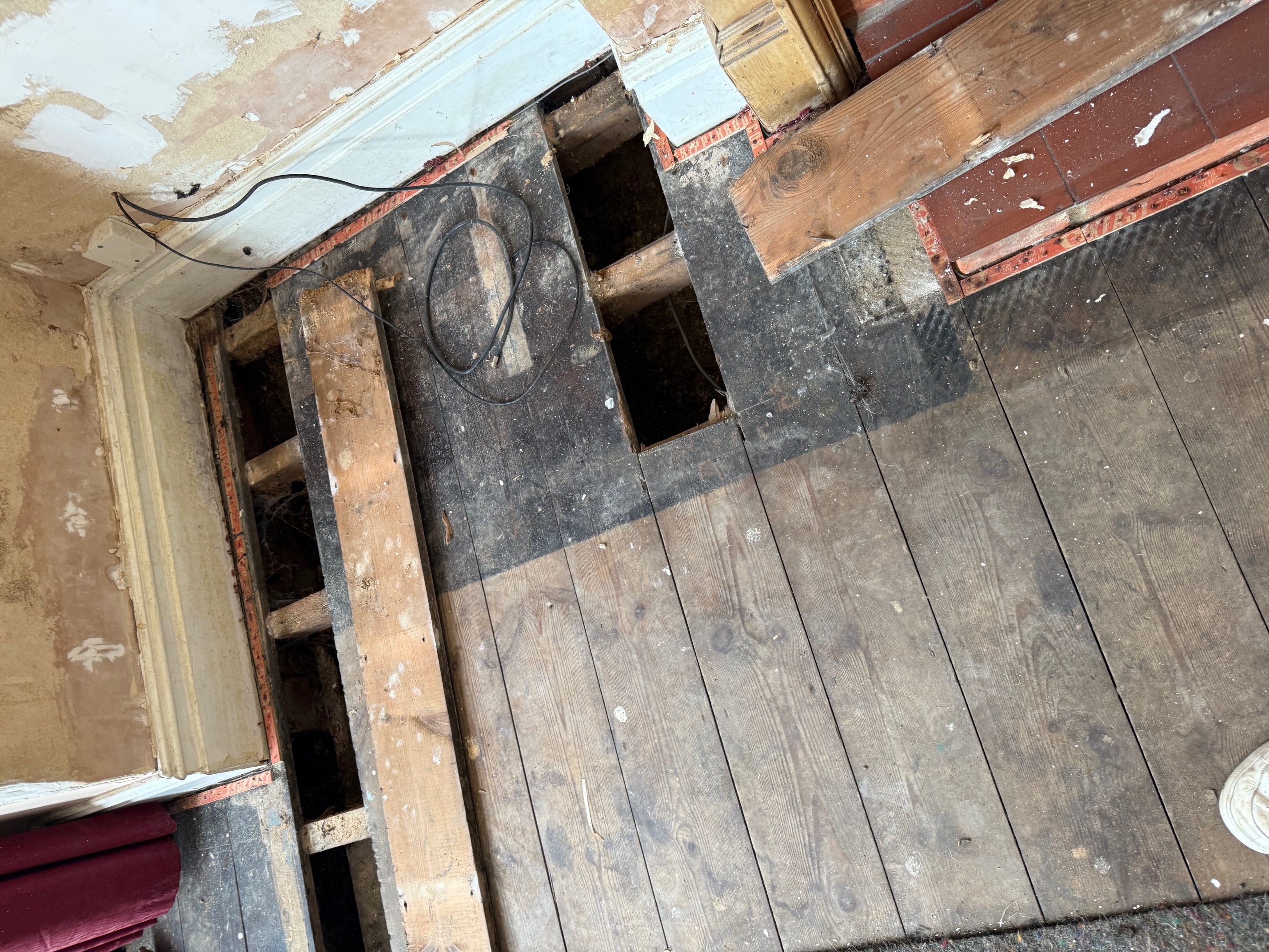 Exposed floor joists and damp damage